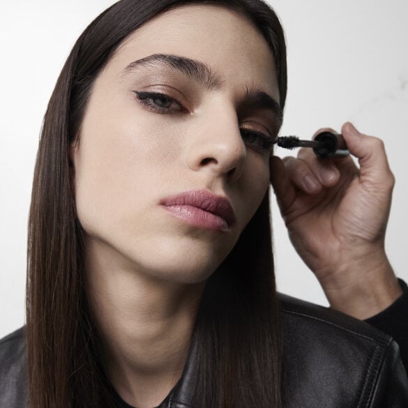 A person applying mascara.