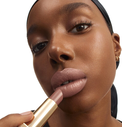 Woman applying lip color