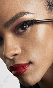 A person holding a product near their face.