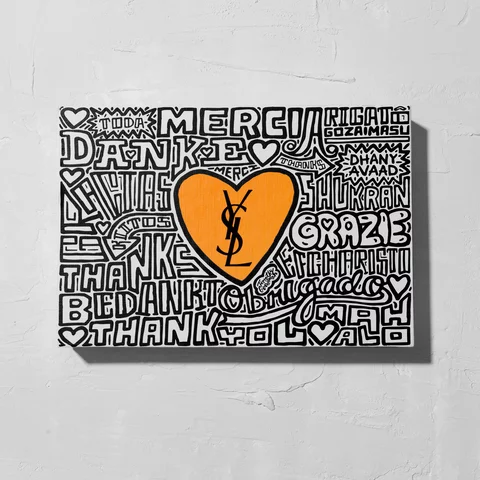 A canvas with various 'thank you' phrases in different languages and a large orange heart with the YSL logo in the center.