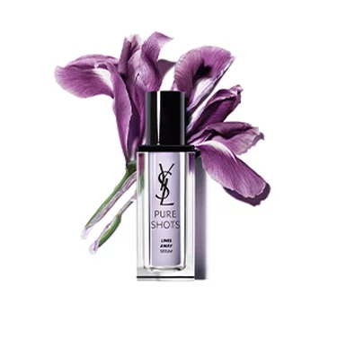 YSL Pure Shots Lines Away Serum bottle with a purple flower in the background.