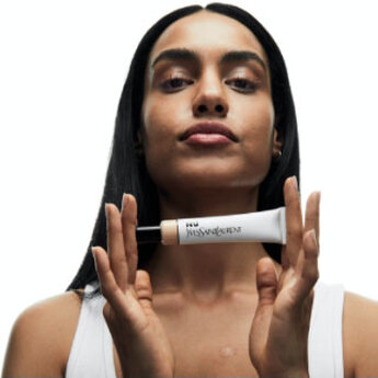 A person holding a tube of YSL Nu product.