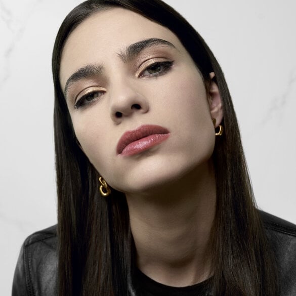 A person with long hair wearing a black leather jacket.