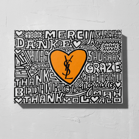 A canvas with a central orange heart featuring the YSL logo, surrounded by the word 'thank you' in various languages.