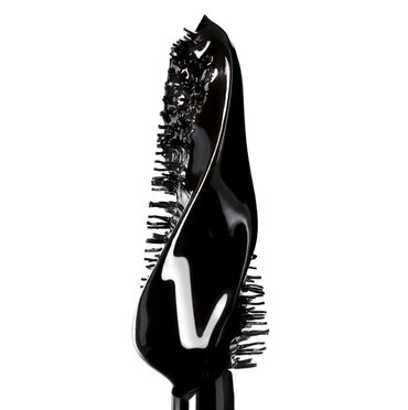 Close-up of a black mascara brush with mascara.