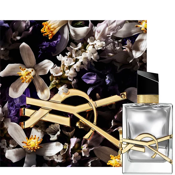 A bottle of YSL perfume with a floral background.