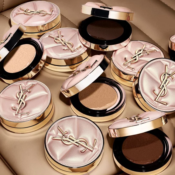 YSL SKIN AFFAIR CUSHION cases in a taxi cup holder with a glass of water. Luxury on-the-go hydration and soft glow.