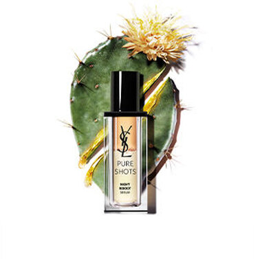 YSL Pure Shots Night Reboot Serum bottle in front of a cactus with a yellow flower.