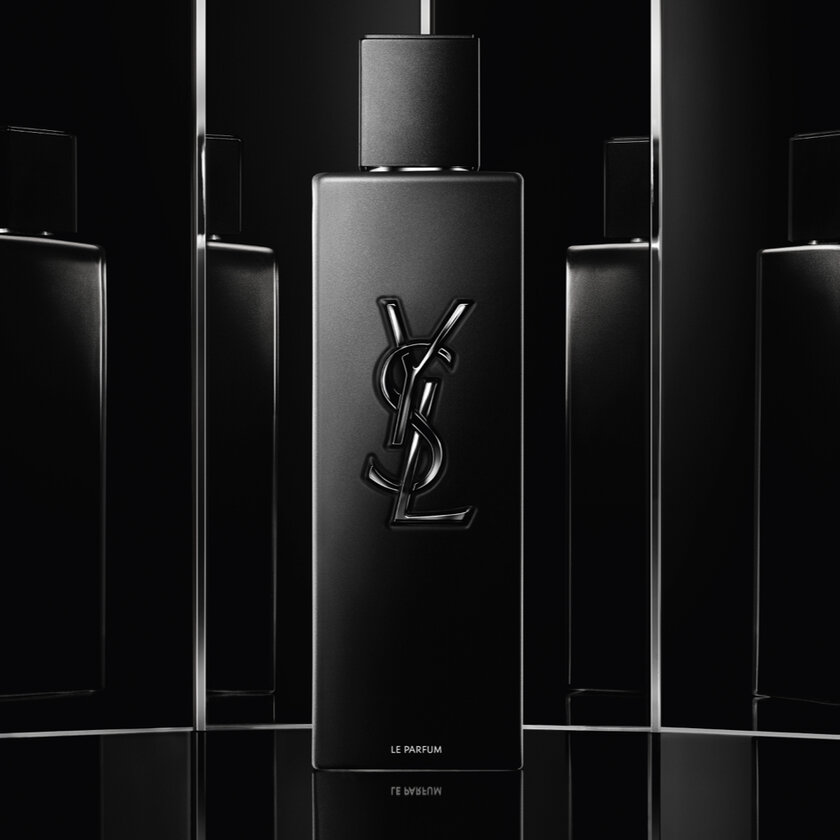 A black YSL perfume bottle with a reflective background.