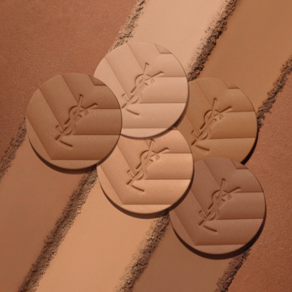 Five YSL powder foundation swatches on a gradient background.