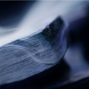 Close-up of a textured surface with a smooth, flowing appearance in shades of blue.