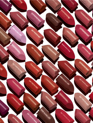 Several shades of YSL lipstick arranged in rows.