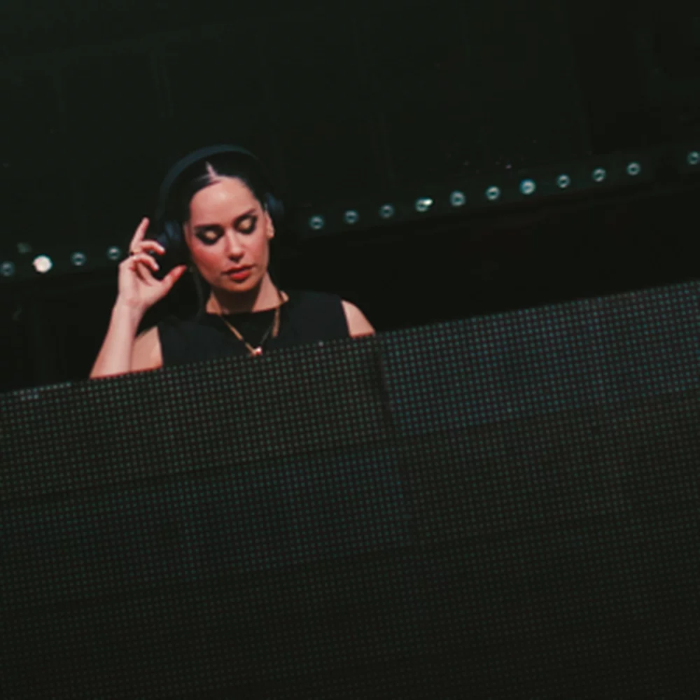 Person performing on stage with the text 'KITTENS' and titles 'ARTIST - DJ - PRODUCER - HOST - PHILANTHROPIST.'
