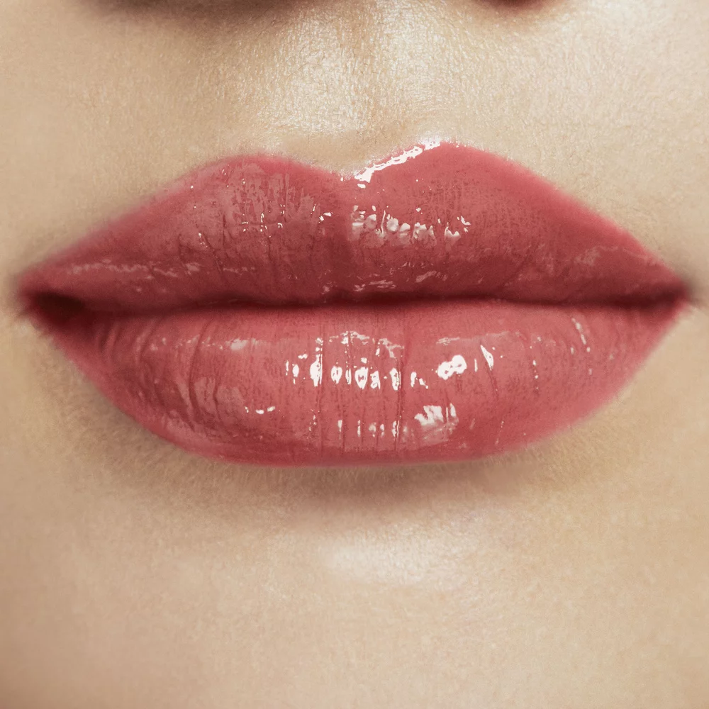 Close-up of glossy pink lips.
