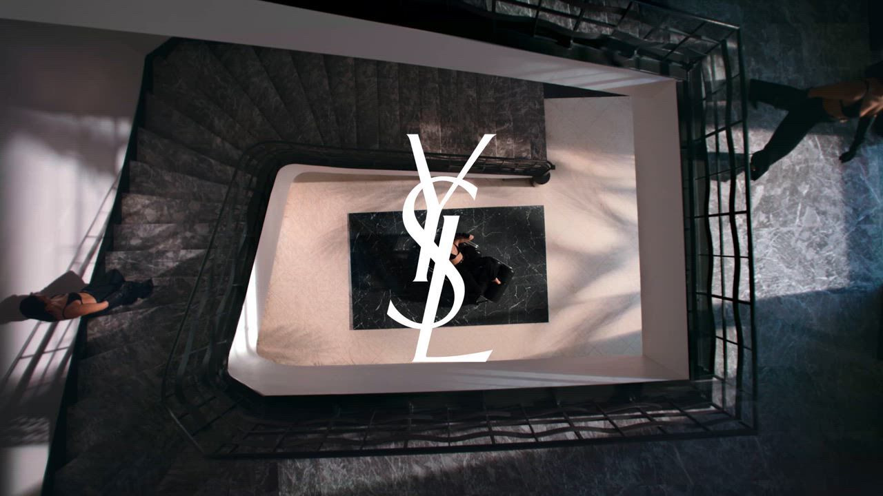 YSL logo viewed from above in a spiral staircase.