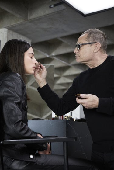 A makeup artist applying makeup to a person.
