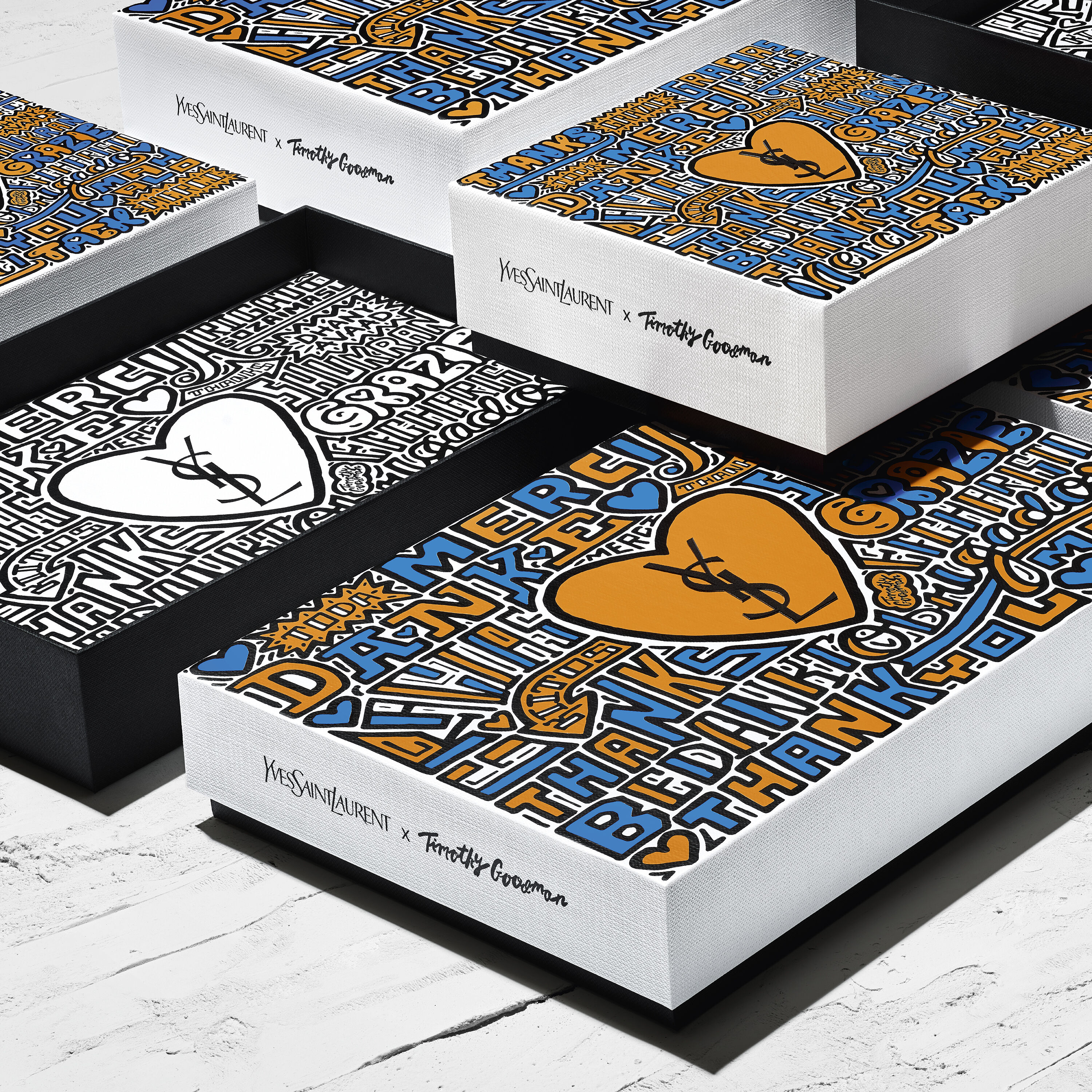Yves Saint Laurent x Timothy Goodman designed boxes with colorful text and heart illustrations.