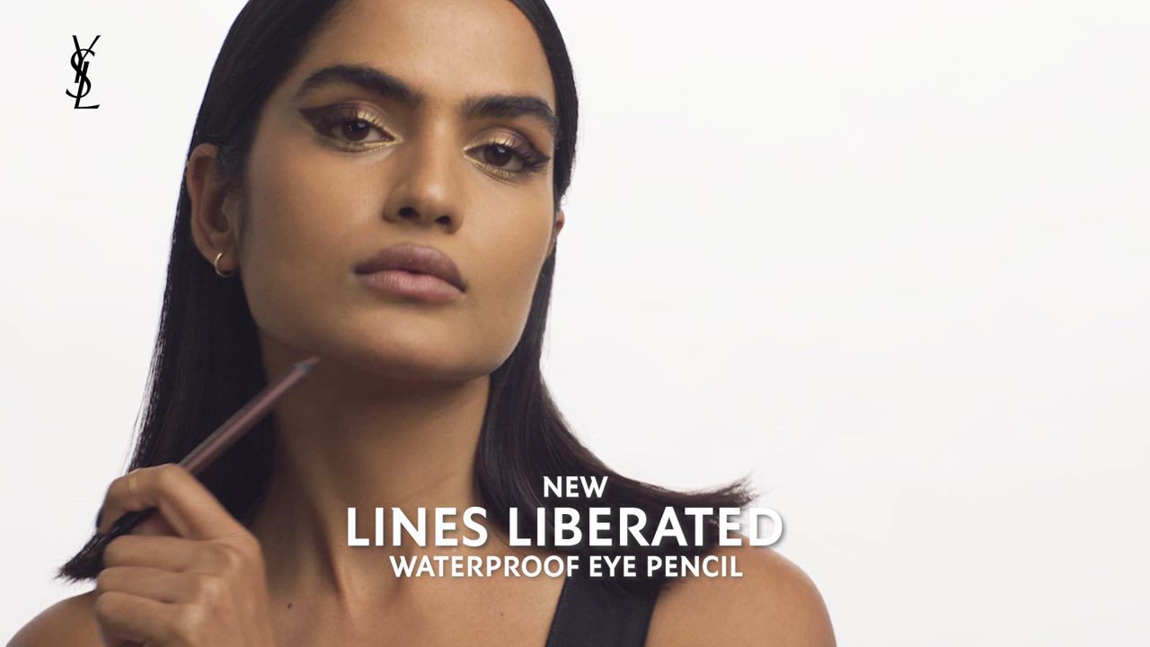 A person applying a waterproof eye pencil with text 'NEW LINES LIBERATED WATERPROOF EYE PENCIL.'
