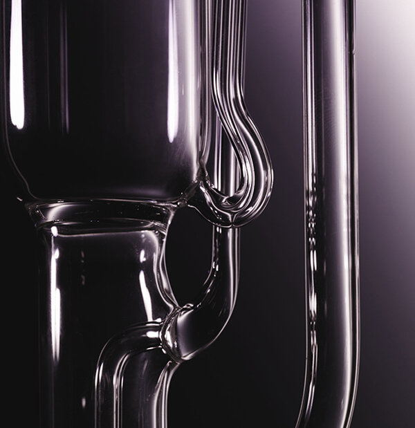 Close-up of a glass apparatus with a dark background.