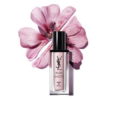 YSL Pure Shots Light Up Serum bottle with a pink flower in the background.