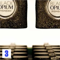 Several bottles of YSL Black Opium perfume with glittery black packaging.