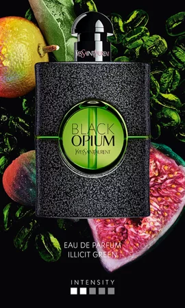 YSL Black Opium Illicit Green perfume bottle with fruits and green leaves in the background.