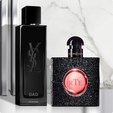 Two YSL perfume bottles on a marble background.