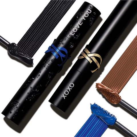 Black tubes of YSL mascara with blue and brown swatches on a white background.