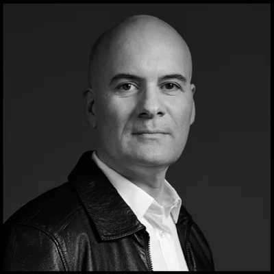 A person in a leather jacket and white shirt.