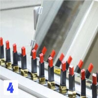Several tubes of YSL lipstick in a row with a mirror in the background.