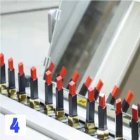 Several tubes of YSL lipstick in a row with a mirror in the background.