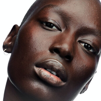 A person holding a tube of YSL Nu product.