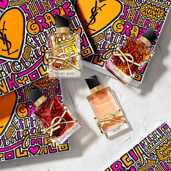 YSL perfume bottles with colorful packaging and 'Best Mom' and 'Love You Mom' labels.