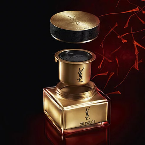 A YSL Or Rouge product with a gold lid and red background.