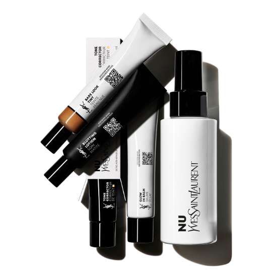 Several tubes and a bottle of YSL Nu makeup products arranged on a white background.