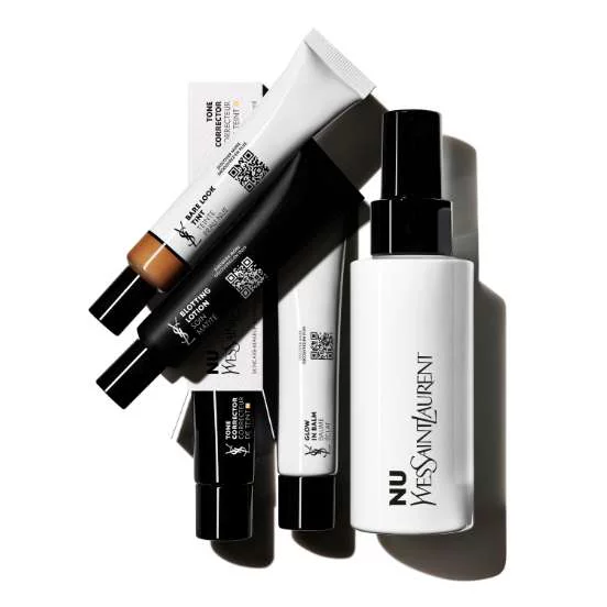Several tubes and a bottle of YSL Nu makeup products arranged on a white background.