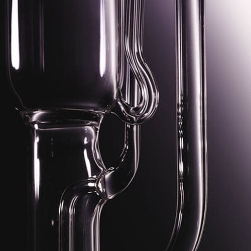 Close-up of clear glass laboratory equipment with a dark background.