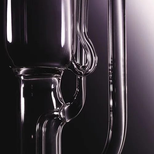 Close-up of clear glass laboratory equipment with a dark background.