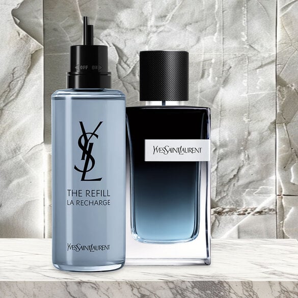 YSL The Refill La Recharge bottle and Yves Saint Laurent perfume bottle on a marble surface.