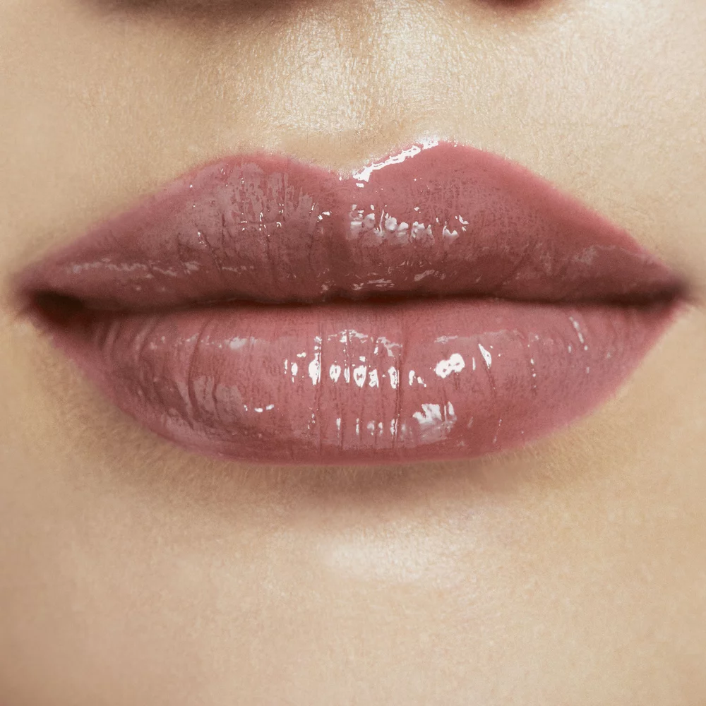 Close-up of lips with a glossy red lipstick.