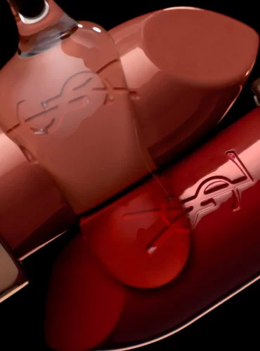 Close-up of YSL lipsticks in various shades with the YSL logo.