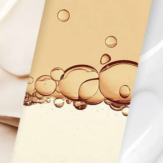 Close-up of bubbles in a golden liquid.