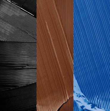 Swatches of black, brown, and blue mascara.