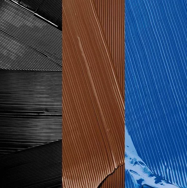 Swatches of black, brown, and blue mascara.