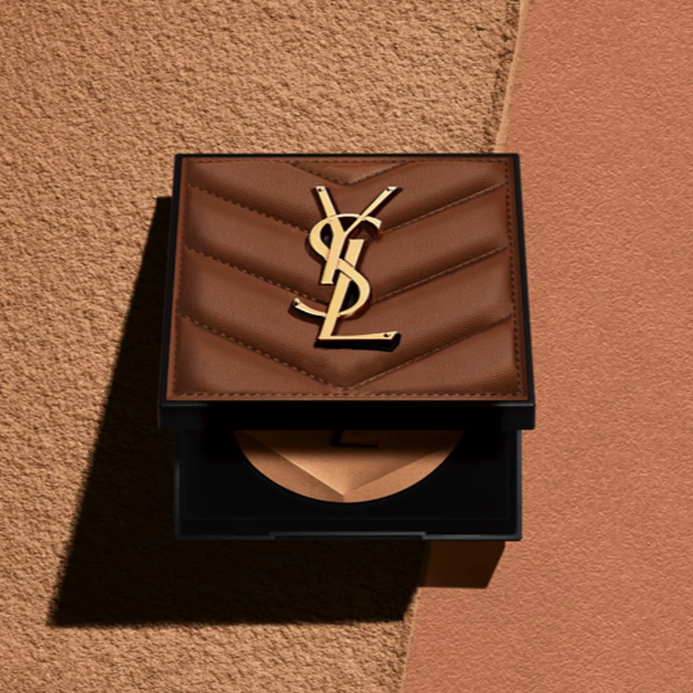 YSL compact with a gold logo on a brown background.